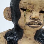ceramic bust of a person with long hair and horns
