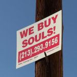 red and white poster on street pole