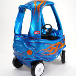 photo of a blue childrens car with painted flames