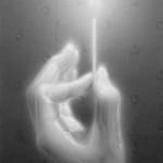 black and white charcoal hand holding a lit match, framed in white