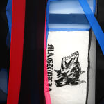 abstract black and red fabric stretched on bars withe a photo of a dog