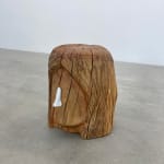 wooden stool shaped into a head with metal nose
