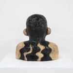 ceramic bust of a person with long hair and horns