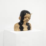 ceramic bust of a person with long hair and horns