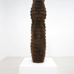 brown hair sculpture on a white pedestal