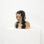 ceramic bust of a person with long hair and horns