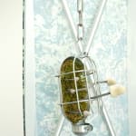 a small dangling metal piece hosing mushrooms