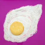 sculpture of a sunny side up egg on a pink canvas backdrop