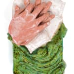 ceramic sculpture of a hand laying in a bed
