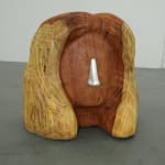 wood carved head with a metal cast nose