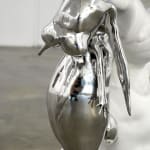 sculpture of a child wearing a hat and holding a bunny