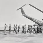 split paimting of a helicopter crash and an abstract section above it