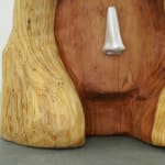 wood carved head with a metal cast nose