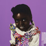 paper collage of a young child on a purple background