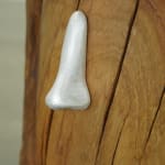 wooden stool shaped into a head with metal nose