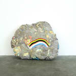 rock sculpture with frown face (rainbow)