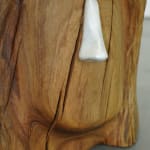 wooden stool shaped into a head with metal nose