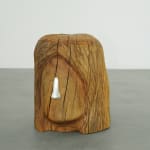wooden stool shaped into a head with metal nose