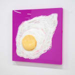 sculpture of a sunny side up egg on a pink canvas backdrop