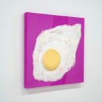 sculpture of a sunny side up egg on a pink canvas backdrop