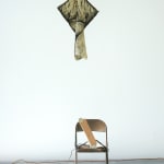 abstract sculpture with a flag with a face painted on it