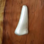 wood carved head with a metal cast nose