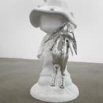 sculpture of a child wearing a hat and holding a bunny