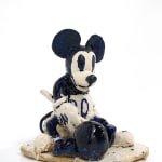 ceramic sculpture of mickey mouse with a ball and chain