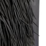 small ceramic needles sewn to a dark indigo canvas