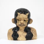 ceramic bust of a person with long hair and horns