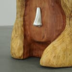 wood carved head with a metal cast nose