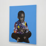 paper collage of a young child on a blue background