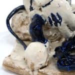 ceramic sculpture of mickey mouse with a ball and chain