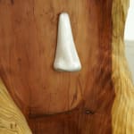 wood carved head with a metal cast nose