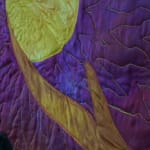 sewn tapestry hanging on wall