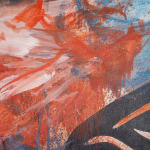 An image of a mixture of red, white, and blue oil paint on a canvas.