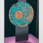 painted abstract circular image depicting sandy colored organic shapes atop a blue background, which is perched on an aluminum base