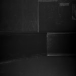 An inkjet print depicting shadowy objects in a dark room.