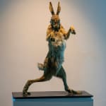 A taxidermy rabbit sculpture on a pedestal in an unrealistic for the animal contrapposto posture.