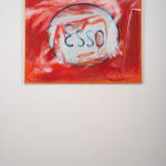 An image of a medium-sized canvas painted red, in its center is a white oval shape which contains the word Esso.
