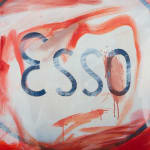 An image of a white oval that contains the word Esso, framed by red.