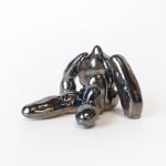 ceramic piece by Jocelyn Tsaih of a silver figure sitting