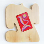 organically-shaped light colored wood sculpture with an inlaid small, vibrant red canvas in the center by Jocelyn Tsaih