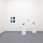 white gallery walls with small artworks and scu
