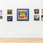 photo of various paintings hung on a white wall