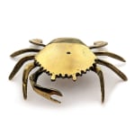 Sculpture of a brass crab with an underwater scene inside of the crab shell