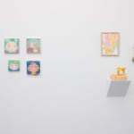 white gallery wall with small assorted artworks