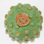 Jen Dwyer sculpture - round green plant with pink flower on top
