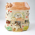 Katie Kimmel ceramic vase made to look like a house with dogs surrounding it