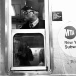 black and white photo of subway train conductor looking out window